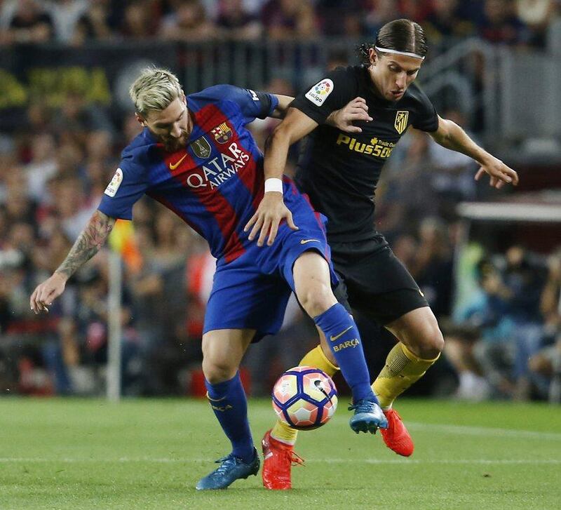 Barcelona's Lionel Messi and Atletico Madrid's Filipe Luis battle for possession on Wednesday night. Pau Barrena / AFP / September 21, 2016