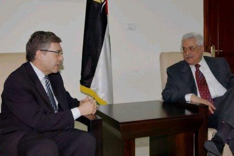 Yossi Beilin, left, has appealed to the Palestinian president, Mahmoud Abbas, right, to begin the dissolution of the Palestinian Authority.