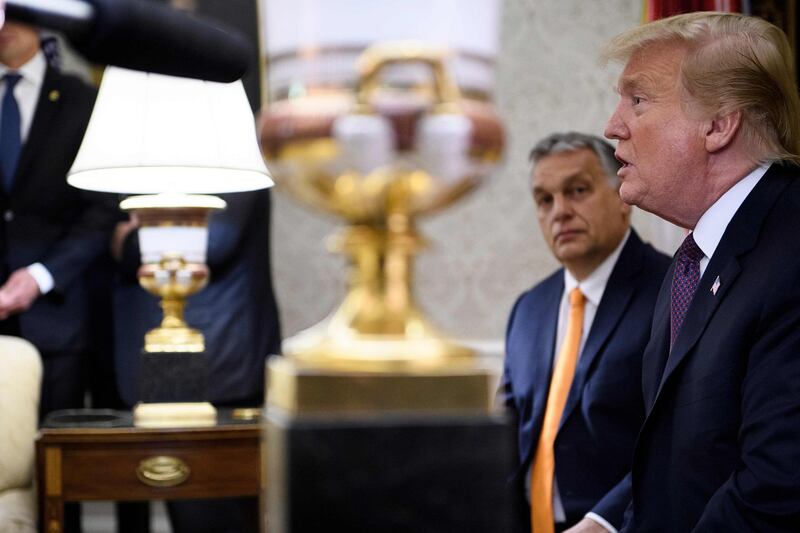 TOPSHOT - Hungary's Prime Minister Viktor Orban listens while US President Donald Trump speaks to the press before a meeting in the Oval Office of the White House on May 13, 2019, in Washington, DC. / AFP / Brendan Smialowski
