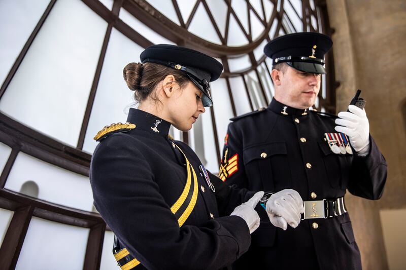 Staff Sergeant Yeoman Darren Fowler, right, and Captain Rebecca Cooper from the Royal Signals at the Elizabeth Tower, checking that Big Ben Chimes in time with gunfire during the state funeral procession. EPA