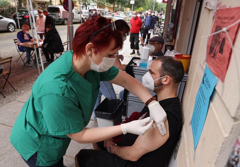 BERLIN, GERMANY - JUNE 13: A medical assistant inoculates a man with the Johnson and Johnson Janssen vaccine against Covid-19 during a local vaccination drive at the Revolte Bar in Friedrichshain district on June 13, 2021 in Berlin, Germany. The bar owner, together with local doctors, organized the drive to administer 200 doses today, with invitations as a thank you gesture having gone out to people from the neighborhood who have supported the bar through the pandemic lockdown. While mass vaccination centers across Germany are administering inoculations at a record pace, many communities have also launched local vaccination drives. Nearly 50% of the population in Germany has so far received a first vaccination dose and coronavirus infection rates have plummeted.   (Photo by Sean Gallup/Getty Images)