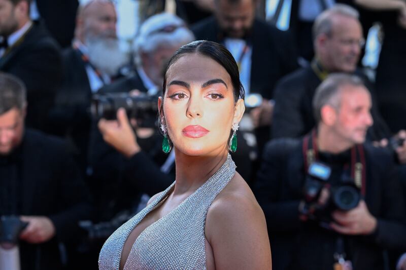 She paired the look with emerald drop earrings. Getty Images