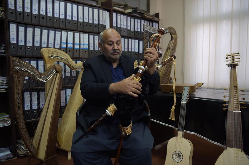 Muhammad Aftab, the owner of the Mid East bagpipe factory, checks a set of bagpipes. AFP.