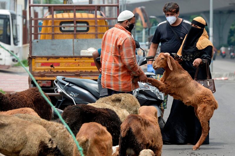 A couple purchases a goat from a roadside trader in Hyderabad. AFP