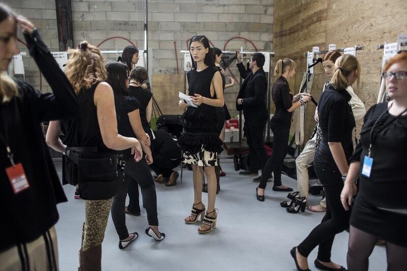 Qiwen Feng, centre, waits backstage prior to the presentation of the Dries Van Noten collection. Yoan Valat / EPA