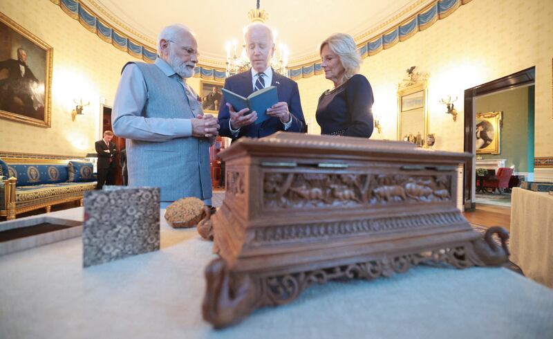 Mr Biden and Mr Modi exchange gifts at the White House. Reuters
