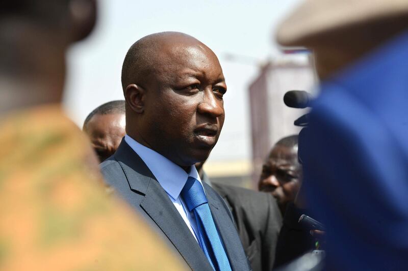 Burkina Faso's Prime Minister Paul Kaba Thieba looks on in front of the Splendid hotel during his visit on January 17, 2016  in Ouagadougou, following a jihadist attack claimed by Al-Qaeda in the Islamic Maghreb (AQIM) late on January 15. - At least 29 people, including at least 14 foreigners, were killed in an Al-Qaeda in the Islamic Maghreb (AQIM) attack on a top hotel in Burkina Faso, an unprecedented strike in the capital illustrating the expanding reach of regional jihadists. (Photo by ISSOUF SANOGO / AFP)