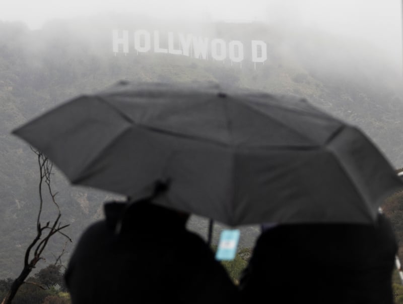 People look at the Hollywood sign during a rare winter storm in the Los Angeles area of California. Reuters