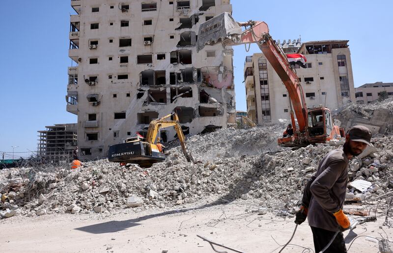 Excavators provided by Egypt help clear the rubble in Gaza City. AFP