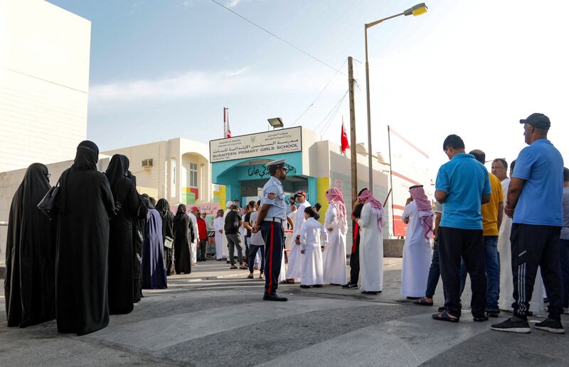 Voters queue outside a polling station on Muharraq island.  Bahrainis will choose from more than 500 candidates, including 94 women, in elections to the 40-seat lower house of parliament and the municipality council. All photos: AFP