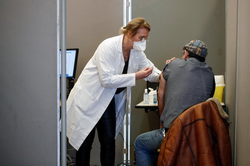 A healthcare worker administers a dose of the Pfizer-BioNTech vaccine at Paris 17th district city hall in Paris, France. Reuters