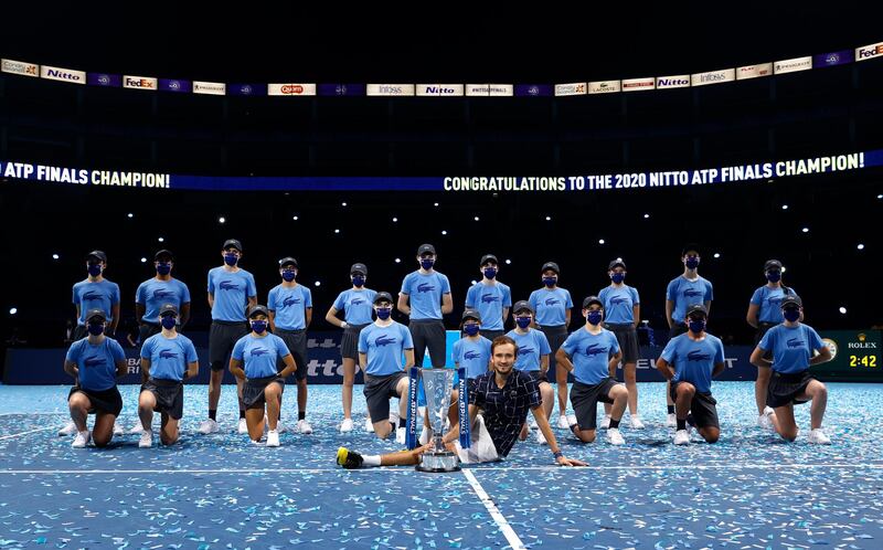 Daniil Medvedev poses with the ATP Finals trophy with ball boys and girls. Getty Images
