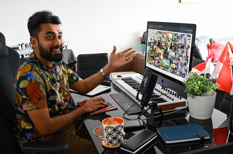 This picture taken on April 7, 2021 shows blockchain entrepreneur Vignesh Sundaresan, also known by his pseudonym MetaKovan, showing the digital artwork non-fungible token (NFT) "Everydays: The First 5,000 Days" by artist Beeple in his home in Singapore. Last month the programmer bought the world's most expensive NFT for $69.3 million, highlighting how virtual work is establishing itself as a new creative genre.  - RESTRICTED TO EDITORIAL USE - MANDATORY MENTION OF THE ARTIST UPON PUBLICATION - TO ILLUSTRATE THE EVENT AS SPECIFIED IN THE CAPTION

TO GO WITH Singapore-US-arts-IT, INTERVIEW by Catherine LAI
 / AFP / Roslan RAHMAN / RESTRICTED TO EDITORIAL USE - MANDATORY MENTION OF THE ARTIST UPON PUBLICATION - TO ILLUSTRATE THE EVENT AS SPECIFIED IN THE CAPTION

TO GO WITH Singapore-US-arts-IT, INTERVIEW by Catherine LAI
