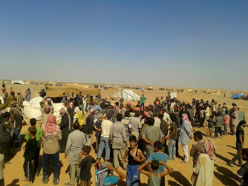 Community leaders distribute meagre food supplies at the Rukban refugee camp. AP