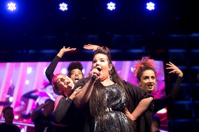 In this Monday, May 14, 2018 photo, Israeli Singer Netta Barzilai, center, who won the 2018 Eurovision song contest performs at Rabin square in Tel Aviv, Israel. Seventy years after Israel's founding, images of victory and violence showcased the contradictions that bedevil the Jewish state. Deadly protests flared along the Gaza border as politicians feted the new U.S. Embassy in Jerusalem and with improbably odd timing, seemingly oblivious to both, euphoric crowds gathered in liberal Tel Aviv to exult the winner of a campy European pop contest. (AP Photo)