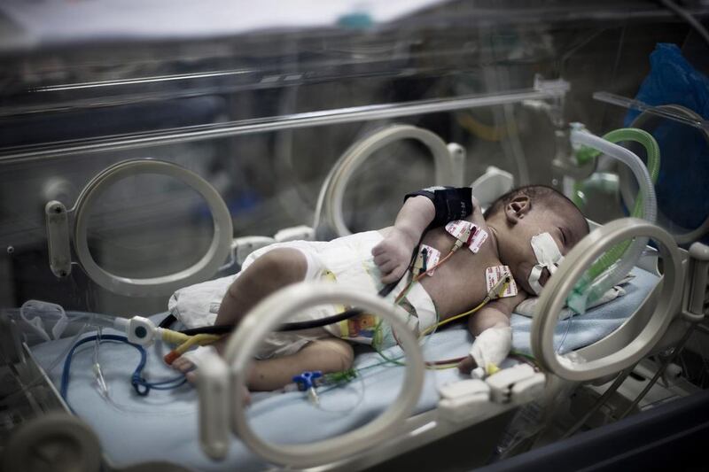 A Palestinian baby lies in the maternity ward at Gaza City’s children’s hospital Al Nasir, which is using solar energy to power its incubators. Mahmud Hams / AFP