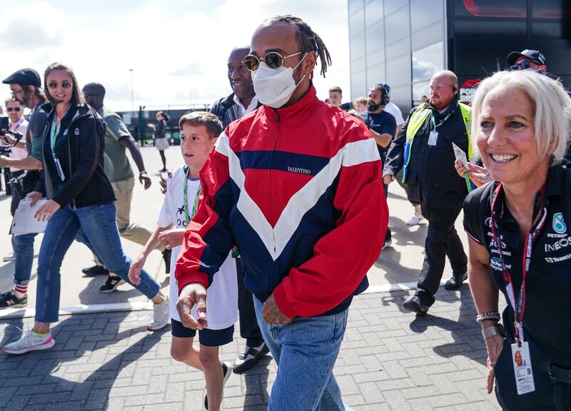 Mercedes driver Lewis Hamilton arrives in the paddock. PA