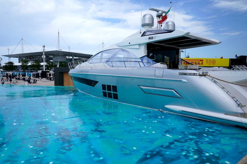 A dry-docked yacht sits on a painted surface simulating water outside Hard Rock Stadium, near which the circuit for the Formula One Miami Grand Prix.