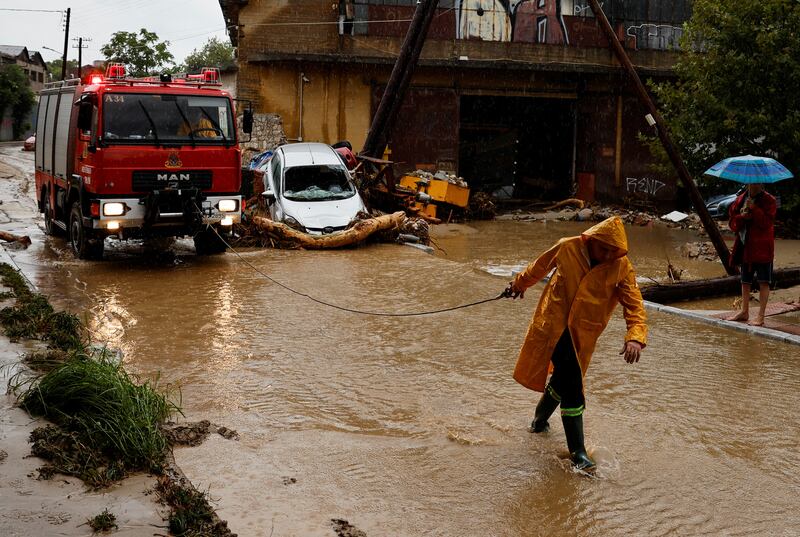 A fireman works on a road flooded due to the impact of storm Daniel in the city of Volos, Greece.  Reuters