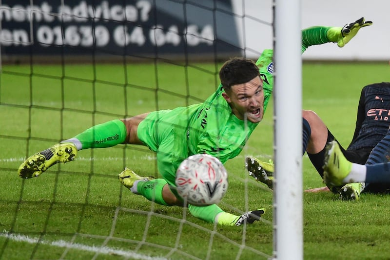 SWANSEA CITY RATINGS: Freddie Woodman – 7. Had his hands warmed by a blistering second minute drive by Jesus, which set the tone for a busy night for Gareth Southgate’s godson. AFP