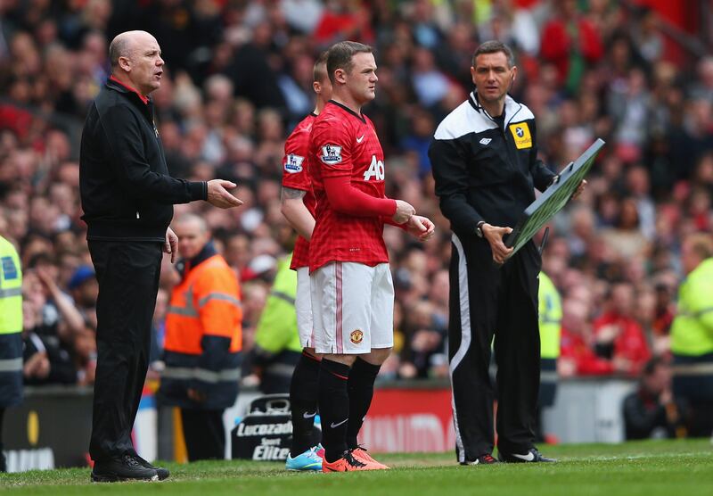 MANCHESTER, ENGLAND - MAY 05:  Wayne Rooney of Manchester United comes on as a substitute for Anderson (not pictured) as Mike Phelan (L), assistant manager gives instructions during the Barclays Premier League match between Manchester United and Chelsea at Old Trafford on May 5, 2013 in Manchester, England.  (Photo by Alex Livesey/Getty Images) *** Local Caption ***  168102410.jpg