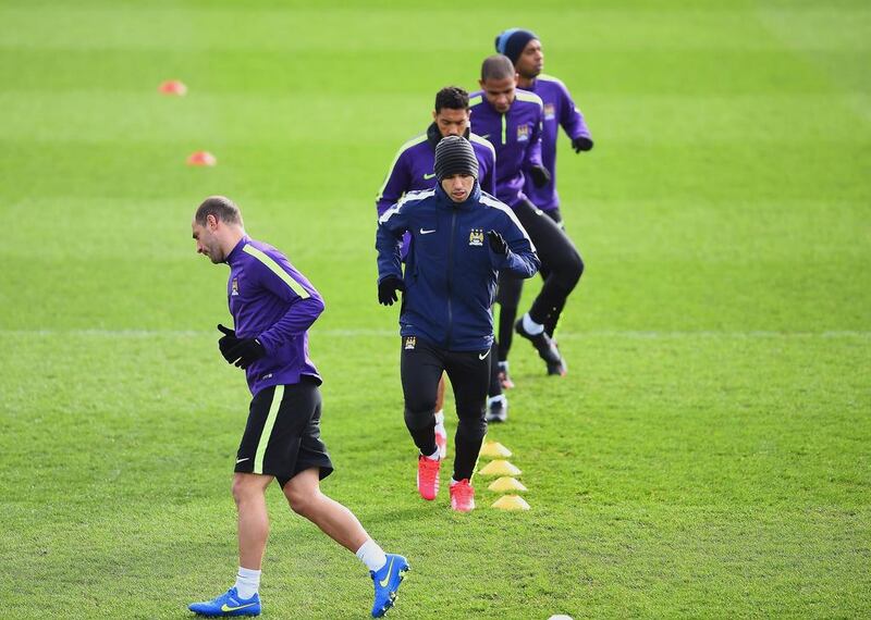 Pablo Zabaleta and Sergio Aguero of Manchester City run drills during Monday's team training session for the Champions League. Laurence Griffiths / Getty Images