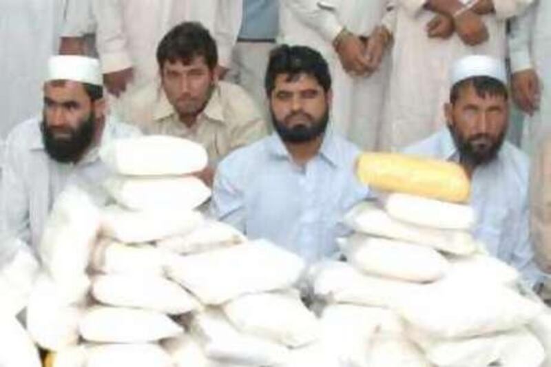 Alleged drug smugglers with 202 kilograms of drugs seized are seen in this handout from the Sharjah Police. (handout)   *** Local Caption ***  drug smugglers.jpg