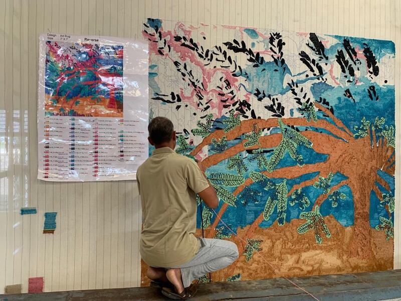 Children from Senses painting a Ghaf tree to be made into a carpet for Dubai Design Week. Courtesy Hands