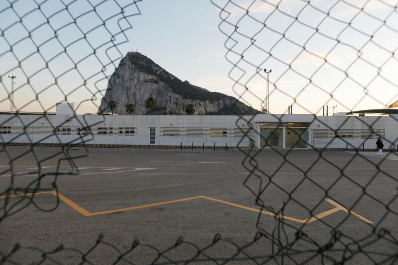 A person crosses the Spanish border from Gibraltar side in front of the Rock of the British overseas territory of Gibraltar, historically claimed by Spain, after Britain and the European Union agreed terms of a trade deal on Brexit on Thursday, in La Linea de la Concepcion, southern Spain, December 24, 2020. REUTERS/Jon Nazca