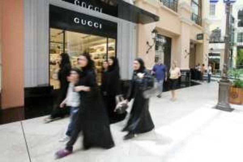 DUBAI, UNITED ARAB EMIRATES - August 4:  Women walk by a Gucci store at the Mall of the Emirates in Dubai on August 4, 2008.  (Randi Sokoloff / The National) *** Local Caption *** RS008-MOE.jpg