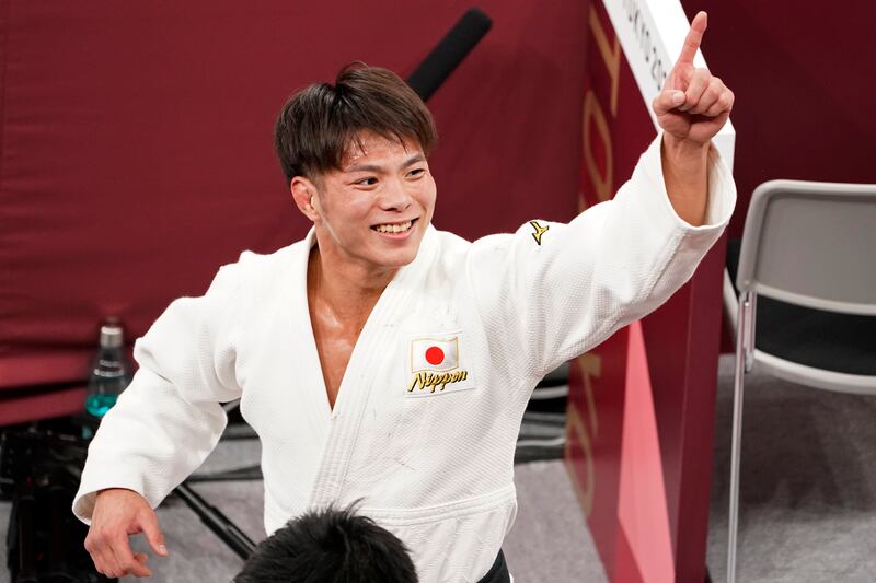 Hifumi Abe, of Japan, celebrates after defeating Vazha Margvelashvili, of Georgia, in the men's -66kg gold medal judo match.