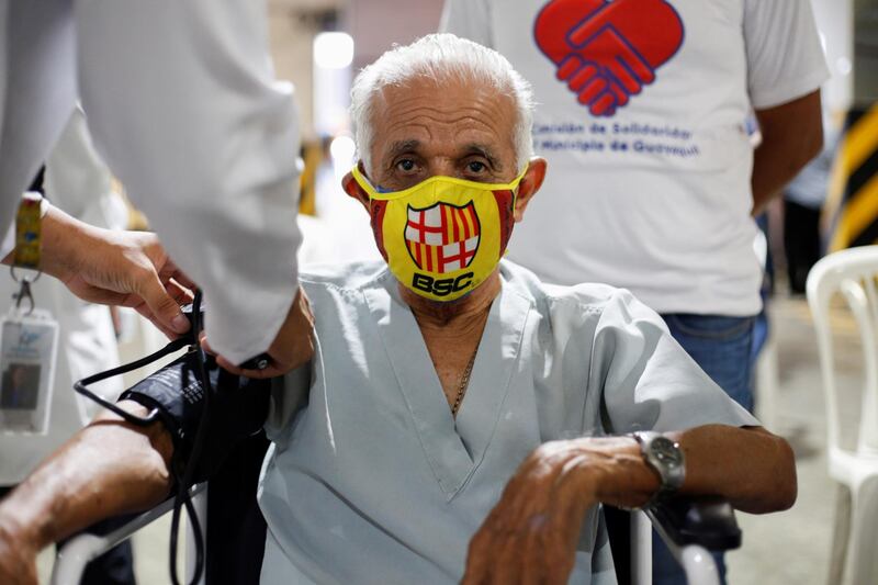 A man gets his vital signs checked by a doctor before entering to get a dose of the coronavirus disease (COVID-19) vaccine during a mass vaccination programme for the elderly, at the Bolivarian Technology Institute, in Guayaquil, Ecuador. Reuters