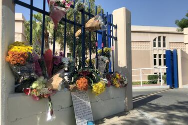 Flowers and soft toys adorn the gates of the school where the accident happened. Antonie Robertson / The National