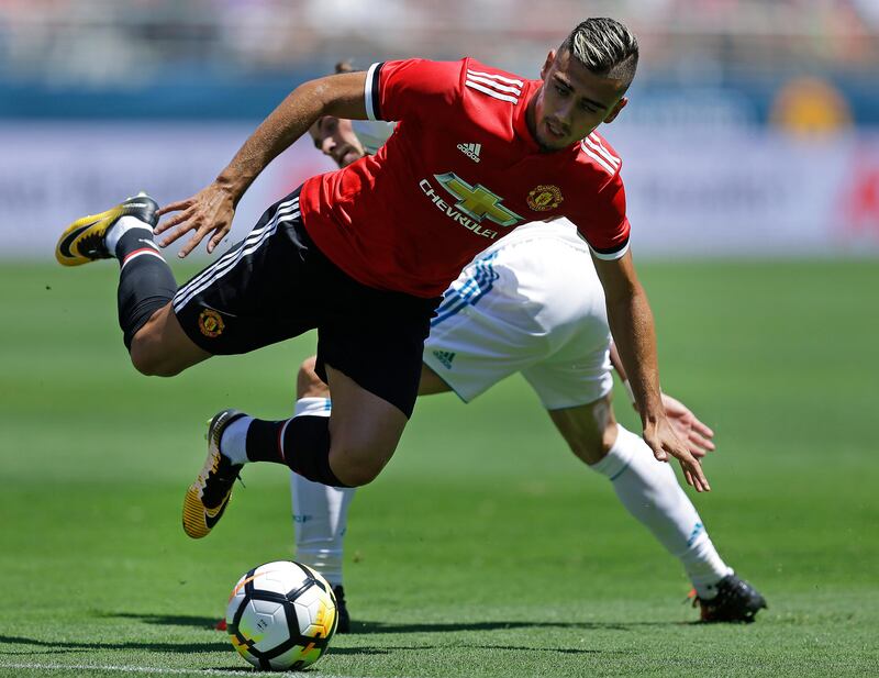 Manchester United's Andreas Pereira, front, and Real Madrid's Gareth Bale go for the ball. Ben Margot / AP Photo