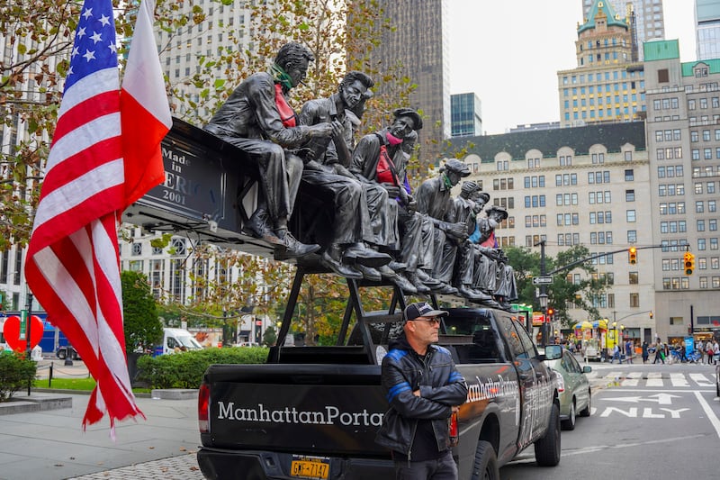 Italian sculptor Sergio Furnari stands next to his car near 'The Hero Monument' sculpture in Manhattan, New York. AP