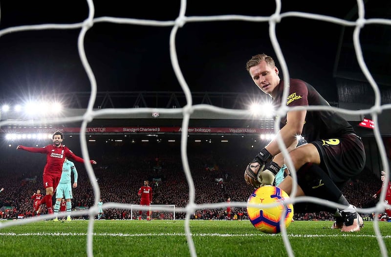 LIVERPOOL, ENGLAND - DECEMBER 29: Bernd Leno of Arsenal shows hos dejection as Mohamed Salah of Liverpool celebrates after his team mate Roberto Firmino has scored the first goal during the Premier League match between Liverpool FC and Arsenal FC at Anfield on December 29, 2018 in Liverpool, United Kingdom. (Photo by Clive Brunskill/Getty Images)