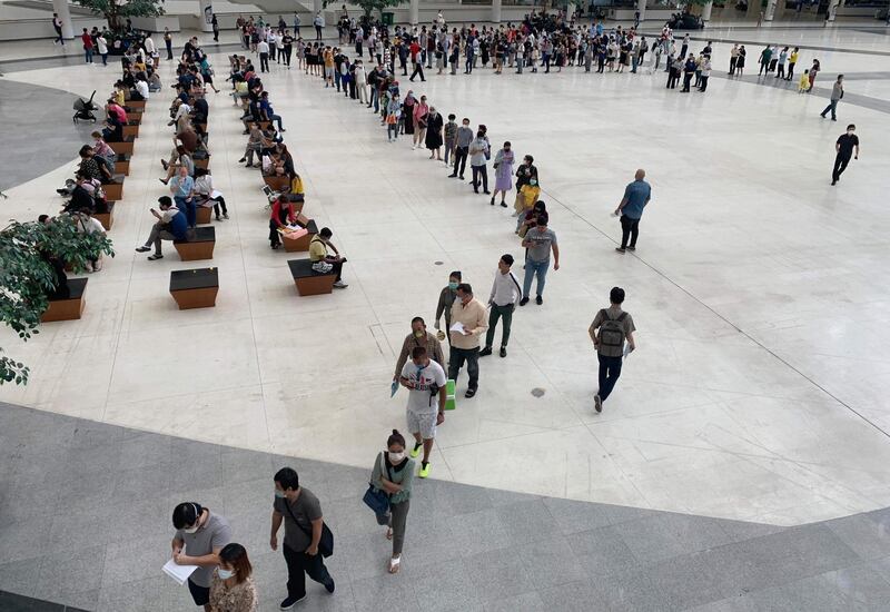 People queue at the Immigration Office in Bangkok, as Thailand moves to close its borders after a spike in the number of coronavirus cases in the past week. AFP