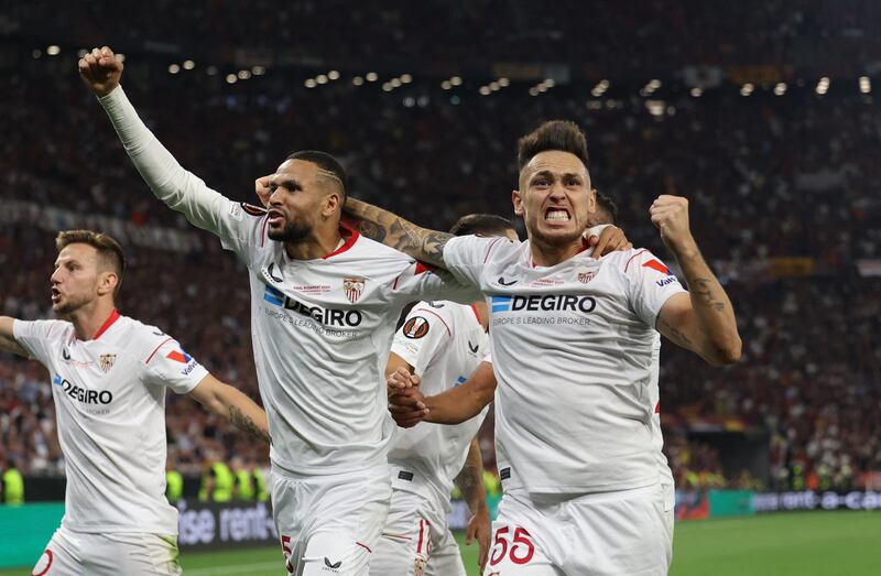 Sevilla's Youssef En-Nesyri and Lucas Ocampos celebrate after AS Roma's Gianluca Mancini scored an own goal. Reuters