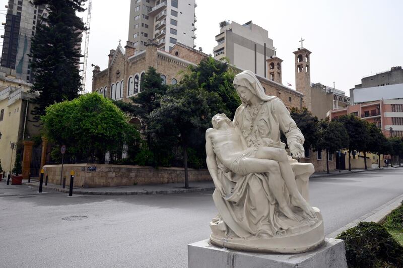 A statue representing the Virgin Mary and Jesus is seen in front of the closed St Maroun Maronite Catholic Church during Mass on Palm Sunday in downtown Beirut, Lebanon.  EPA