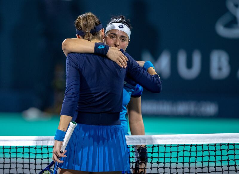 Ons Jabeur embraces Belinda Bencic after their match at the Mubadala World Tennis Championship. Victor Besa / The National
