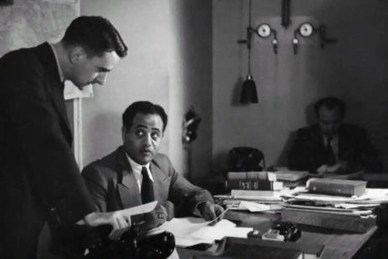 22 Jun 1938, London, England, UK --- D. Stephenson, Arabic Sub Editor of the BBC, consults with H.M. Da Souki, relief translator and announcer of the BBC Arabic service. --- Image by © BBC/Corbis