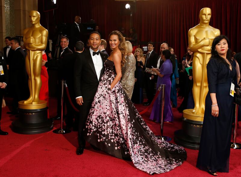 John Legend and Teigen on the red carpet at the 86th Academy Awards in Hollywood, California, on March 2, 2014. Reuters