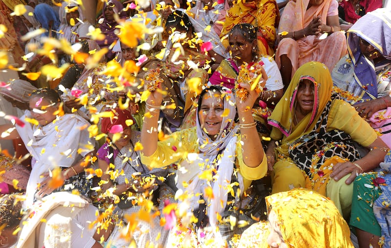 Indian widows throw petals during Holi festivities in Vrindavan, Uttar Pradesh, India, known as the Festival of Colours. EPA