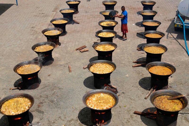 A man cooks traditional curries before Muslims break their fast at a mosque during Ramadan in Banda Aceh, Indonesia. AFP