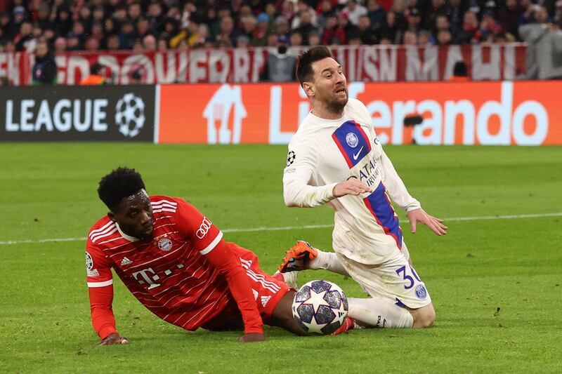 PSG's Lionel Messi is tackled by Alphonso Davies of Bayern Munich. Getty