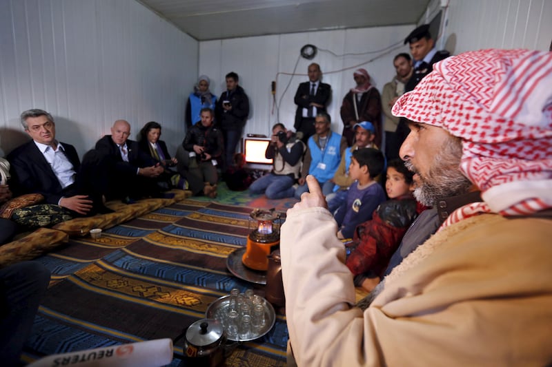 United Nations High Commissioner for Refugees Filippo Grandi, left, with a Syrian refugee family during his visit to Zaatari, which is near the Jordanian city of Mafraq and close to the border with Syria. Reuters