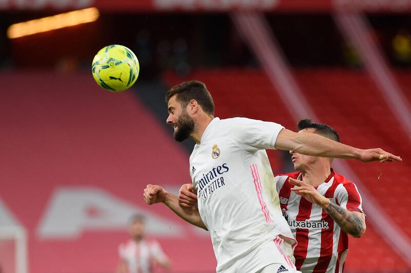 Real Madrid's Spanish defender Nacho Fernandez vies with Athletic Bilbao's Spanish forward Alex Berenguer. AFP