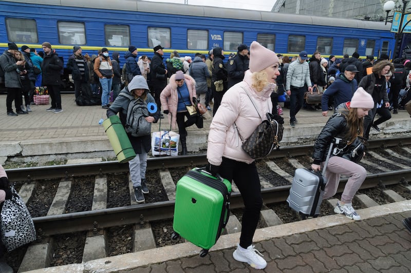 People gather to catch a train and leave Ukraine for neighboring countries at the railway station in Lviv, western Ukraine. AP