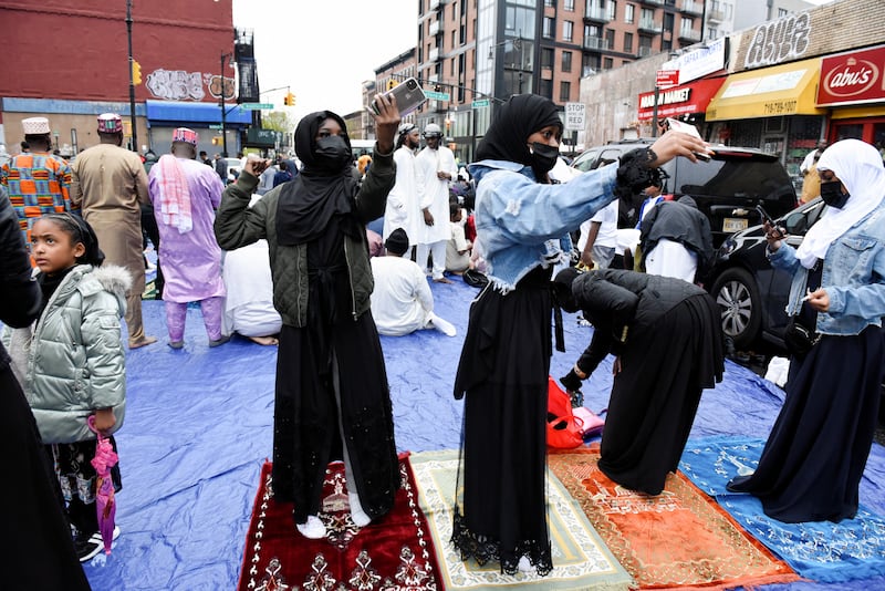 Women take selfies during Eid Al Fitr celebrations. Reuters