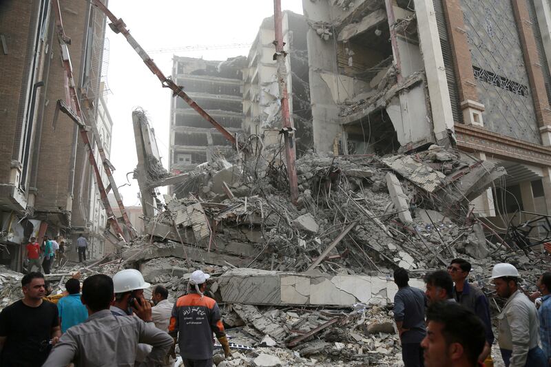 Rescue crews work at the site of the 10-storey building that collapsed in Abadan. Reuters
